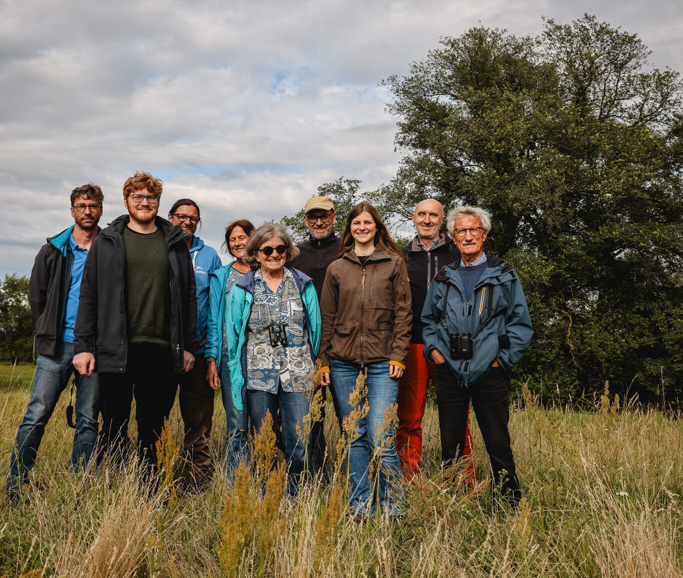 Teilnehmende an Besuch Anne Cura stehen auf Wiese